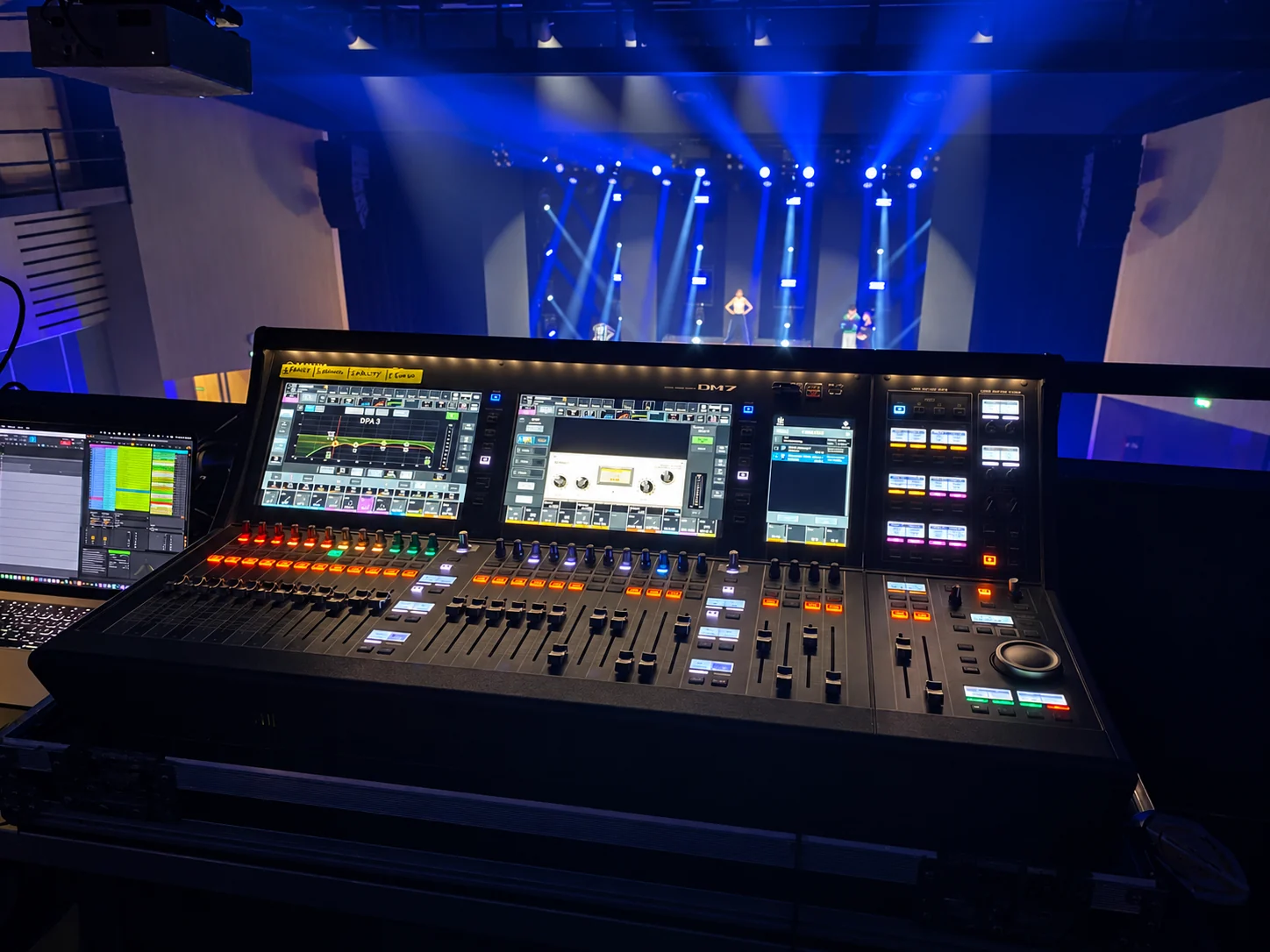 View from the control desk towards the lit stage — retouched photograph